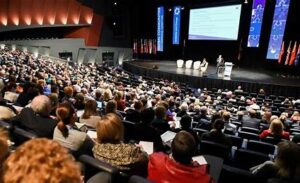 "Graduate Engineer Trainee (GET) induction session – Fresh graduates attending a corporate orientation, listening to speakers, and networking."